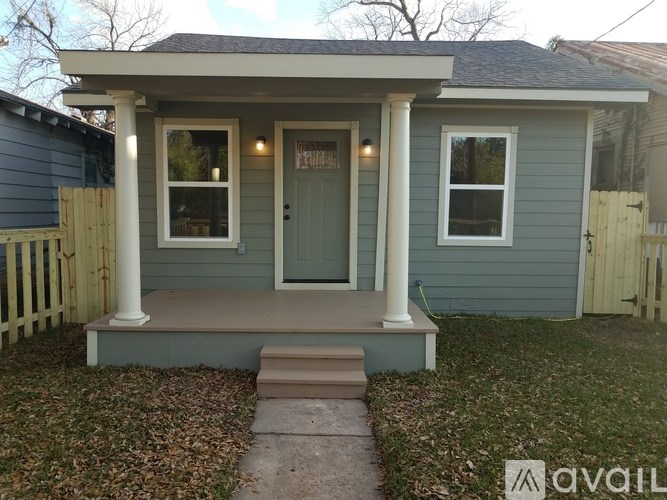 A small house with a front porch and a front door.