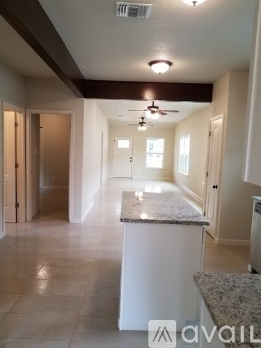 A long, empty hallway with a marble counter in the middle.