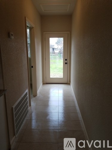 A hallway with a door at the end.