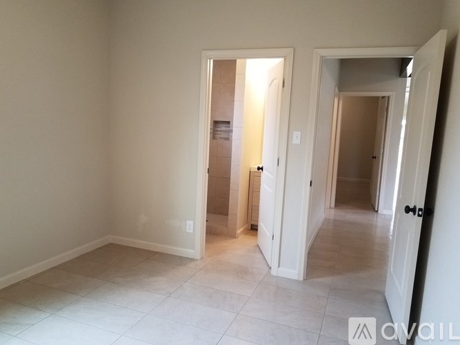 A room with a white door and a white wall.