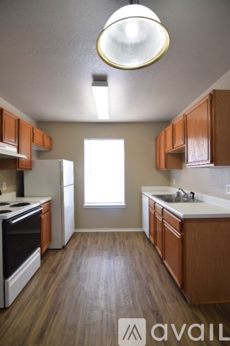 A kitchen with wooden cabinets and a white fridge.