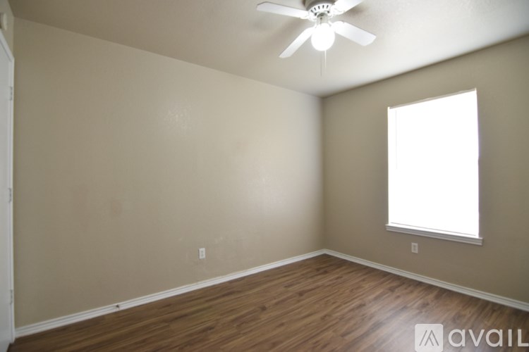 A room with a ceiling fan and a window.