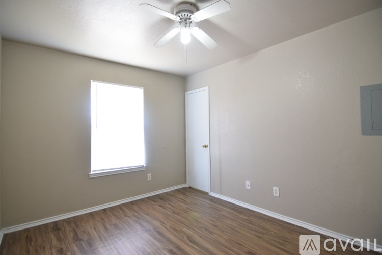 A room with a ceiling fan and a window.