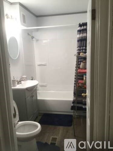 A bathroom with a toilet, sink, and bathtub.
