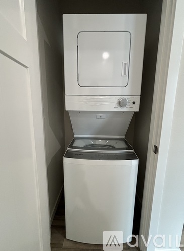 A white washing machine and dryer in a small laundry room.