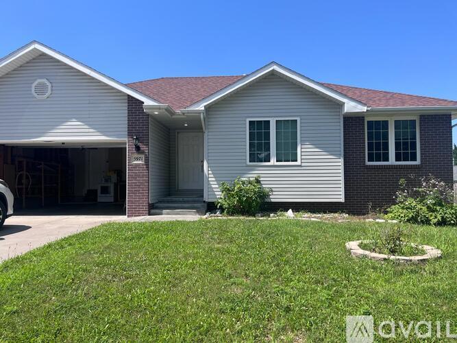 A house with a garage and a driveway in front.