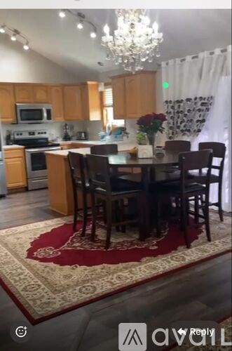 A kitchen with a dining table and chairs.
