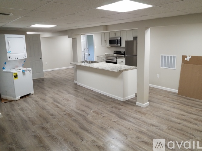 A kitchen area with a refrigerator, microwave, and oven.