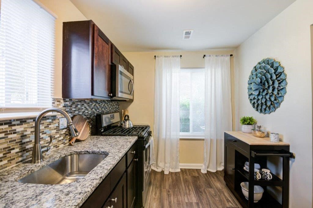 a kitchen with a sink and a microwave