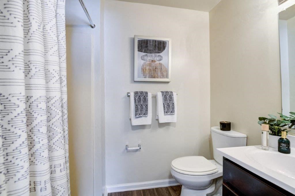 a bathroom with a toilet and a shower curtain