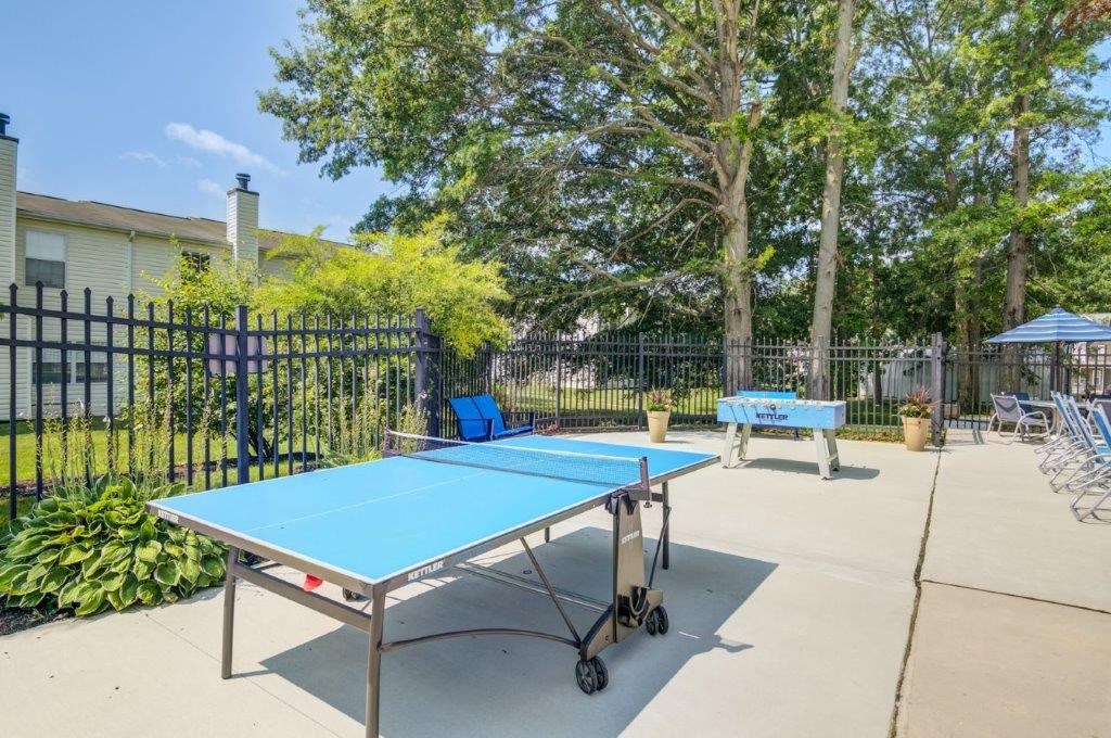 enjoy a game of ping pong at the clubhouse patio with tables