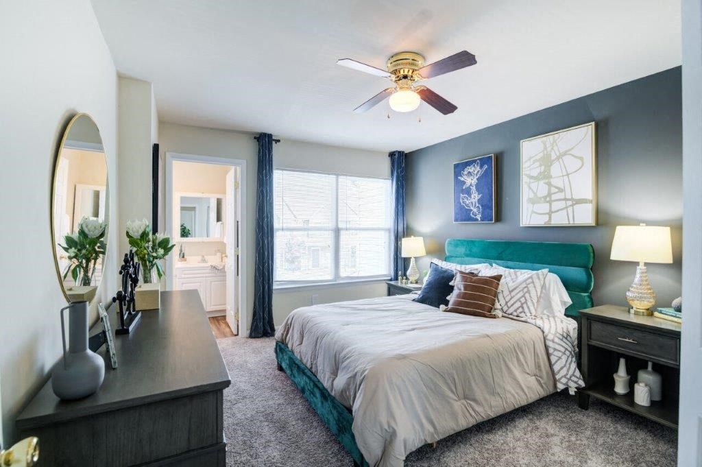 a bedroom with a bed and a ceiling fan