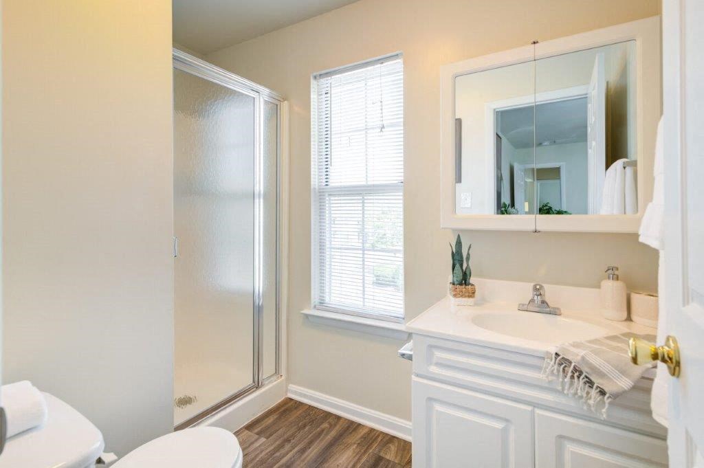 a bathroom with a shower and a sink and a mirror