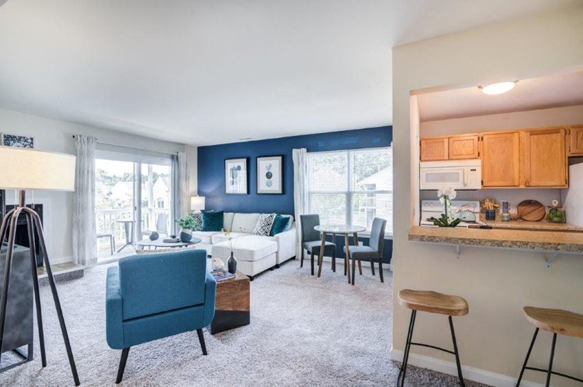 a living room with a kitchen and a couch