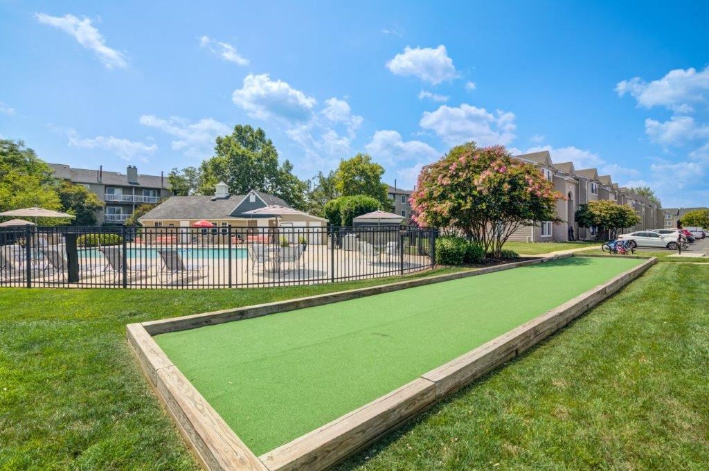 a putting green in a yard next to a fence