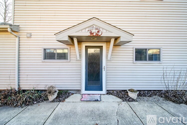 A house with a blue door and two windows.