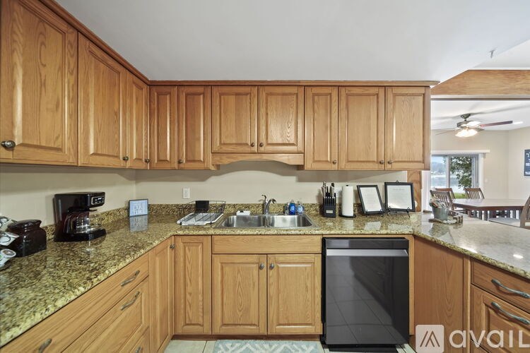 A kitchen with wooden cabinets and granite countertops.