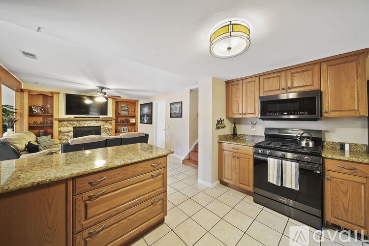 A kitchen with wooden cabinets and black appliances.