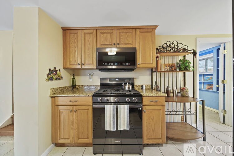 A kitchen with wooden cabinets and a black stove top oven.
