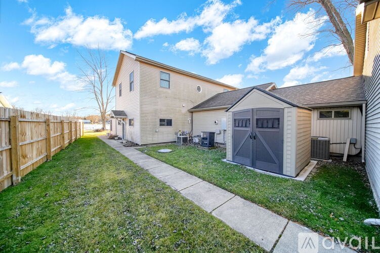 A sunny day at a residential area with houses and a fence.