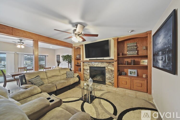 A living room with a fireplace and a television.