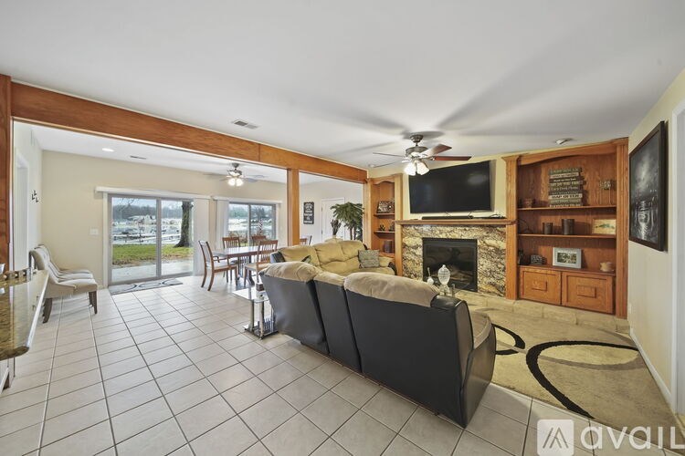 A living room with a fireplace and a television.