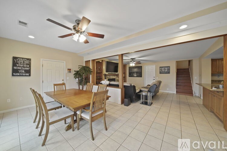 A dining room with a wooden table and chairs.