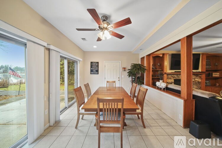A dining room with a wooden table and chairs.
