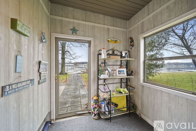 A room with a window and a door leading outside.