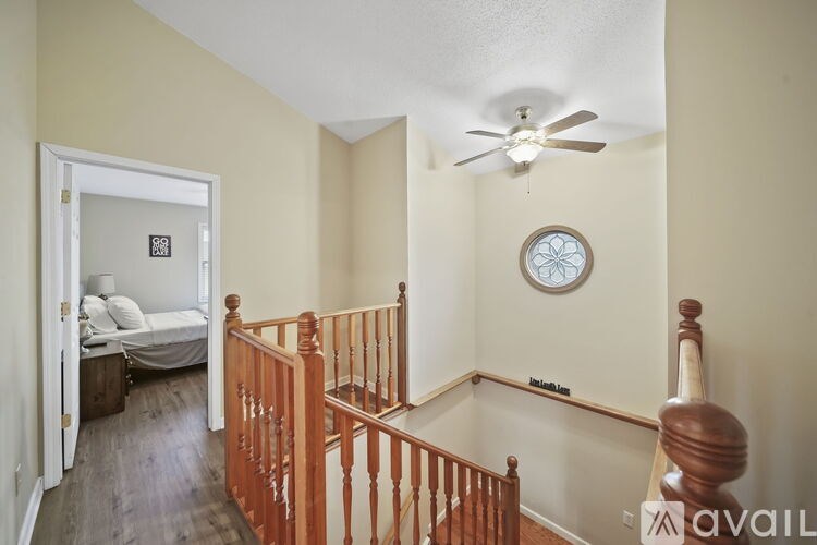A bedroom with a bed and a ceiling fan.