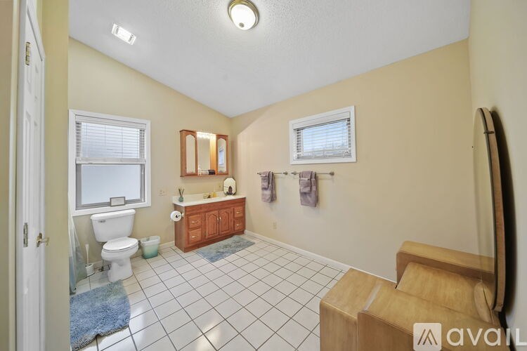 A bathroom with a toilet, sink, and bathtub.
