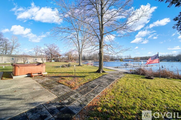 A view of a park with a lake and a flag.