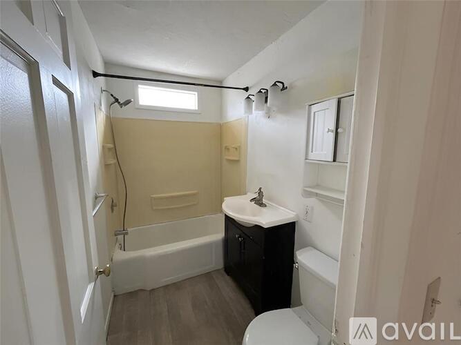 A bathroom with a toilet, sink, and bathtub.