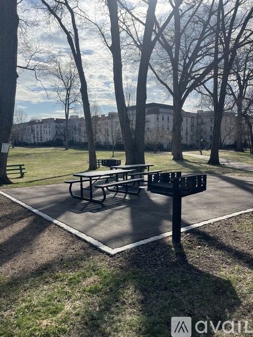 A picnic table is in the middle of a park.