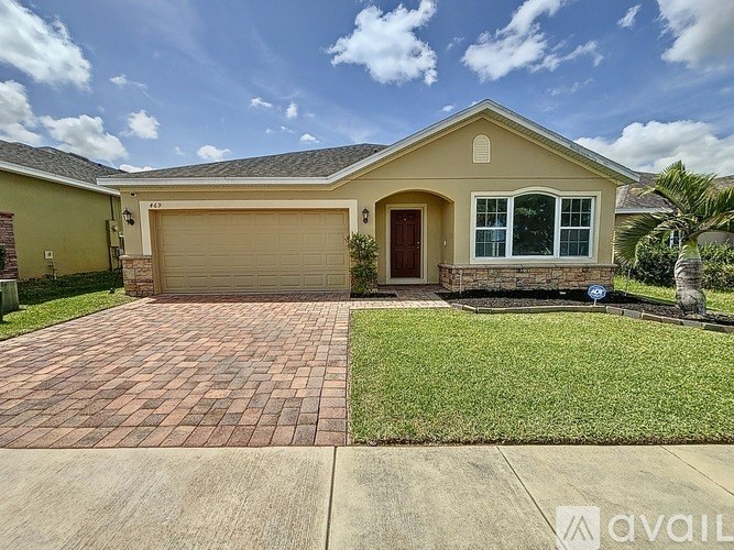 A house with a garage and a driveway in front.