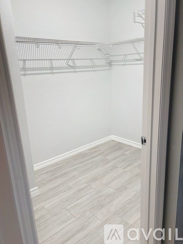 A white closet with a white door and a white wall.