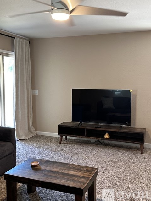 A living room with a television and a coffee table.