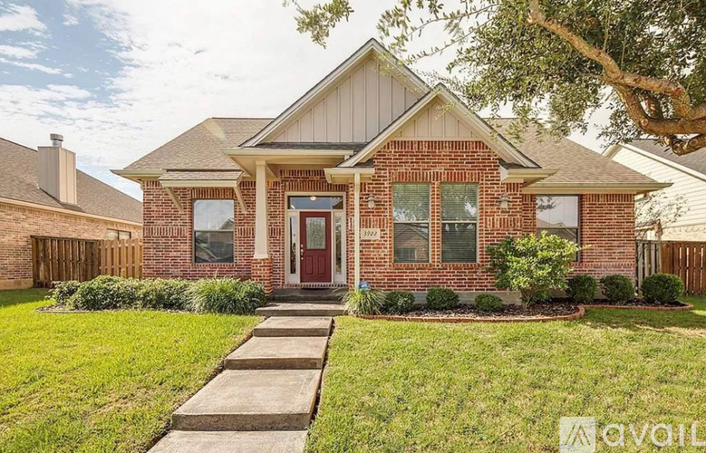 A house with a red door and a brick facade is for sale.
