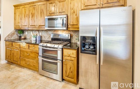 A kitchen with wooden cabinets and stainless steel appliances.