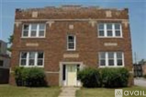 A brick house with a white door and windows.