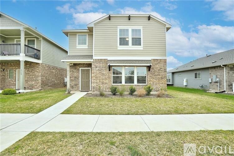 A two-story house with a balcony on the first floor.