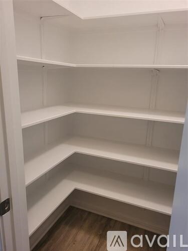 Empty white shelves in a room.