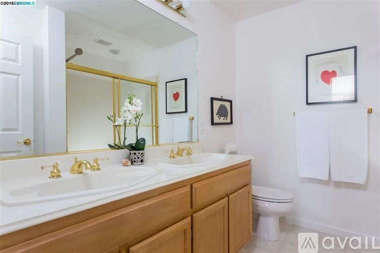 A bathroom with a white sink and a mirror above it.