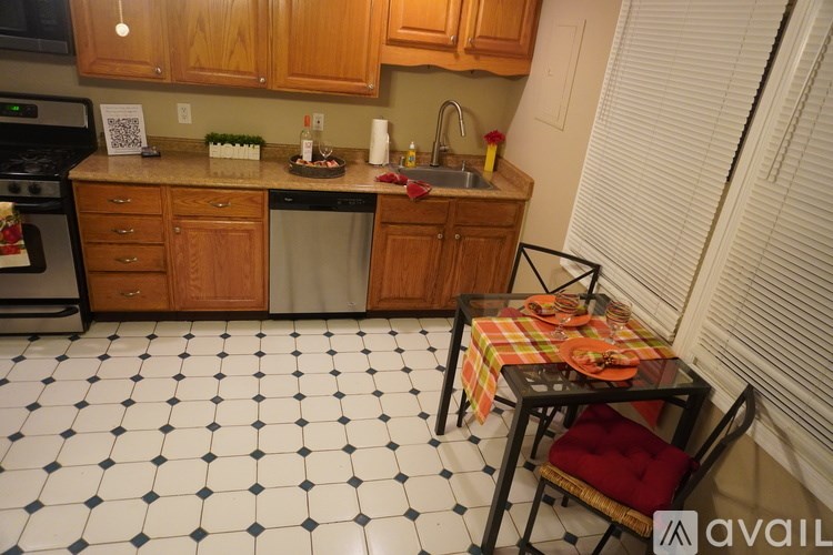 A kitchen with a table set for two.