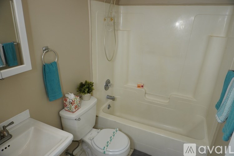 A bathroom with a toilet, sink, and bathtub.