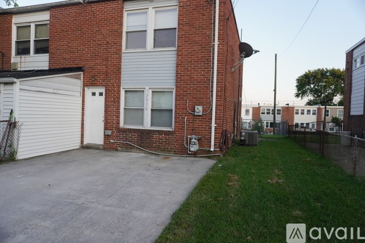 A brick house with a garage door and a driveway.
