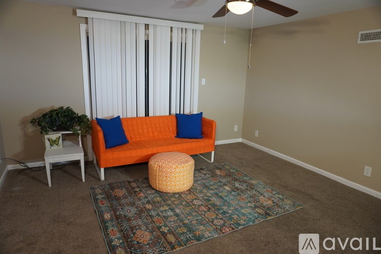 A living room with a sofa, a small table, and a rug.