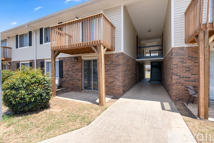 A building with a balcony and a doorway.