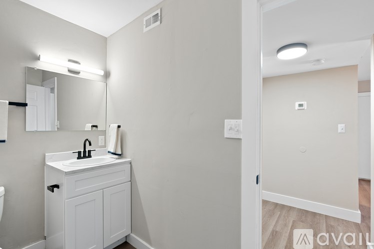A bathroom with a white cabinet and sink.