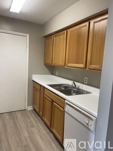 A kitchen with wooden cabinets and a white countertop.